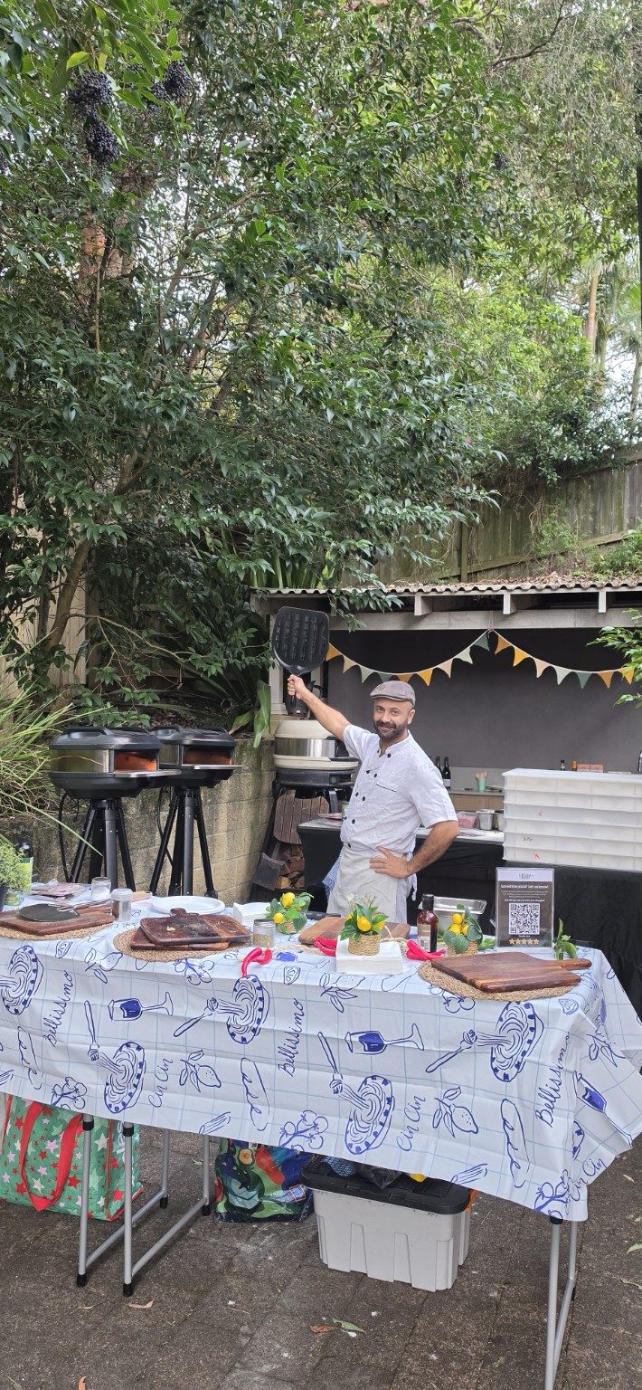 Azzurri pizzaiolo working twin mobile pizza ovens at a private Sydney event, fresh pizza cooked on-site Azzurri pizzaiolo working twin mobile pizza ovens at a private Sydney event, fresh pizza cooked on-site