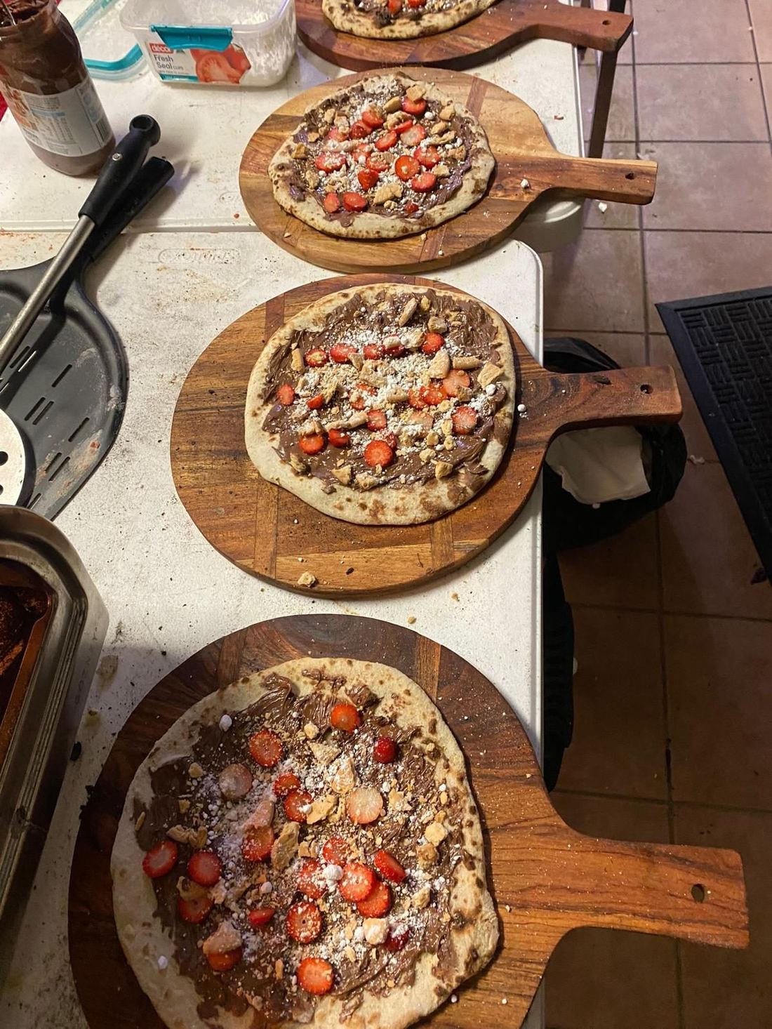 Sweet dessert pizzas with Nutella and fresh strawberries — Azzurri Pizza Catering signature dessert offering for weddings Sweet dessert pizzas with Nutella and fresh strawberries — Azzurri Pizza Catering signature dessert offering for weddings