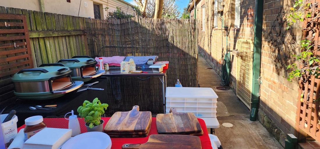 Azzurri Pizza Catering professional mobile setup — authentic Italian pizza ovens, fresh basil, La Stella mozzarella, wooden cutting boards ready for a Sydney event Azzurri Pizza Catering professional mobile setup — authentic Italian pizza ovens, fresh basil, La Stella mozzarella, wooden cutting boards ready for a Sydney event
